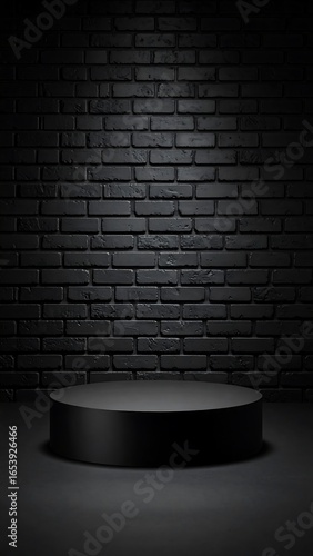 Dark, empty, circular podium in front of brick wall