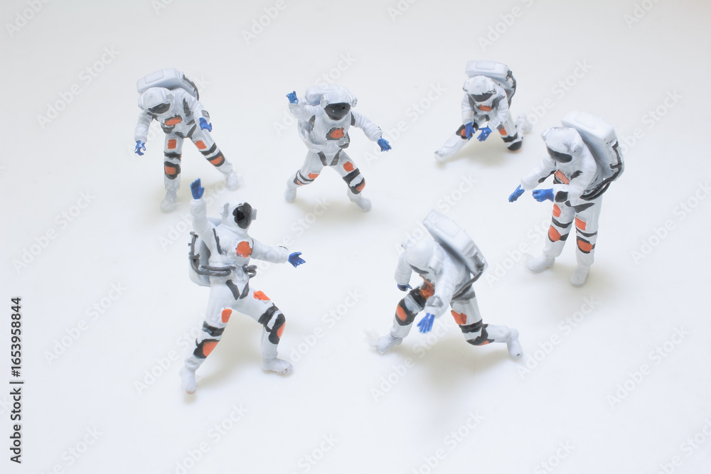 Fototapeta premium Group of Miniature Astronaut Figures in Space Exploration Suits