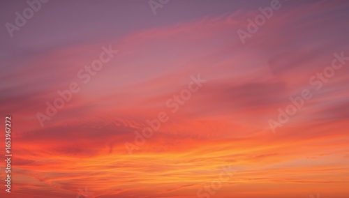 Fiery Skies. A Vivid Display of Orange and Pink Clouds at Sunrise or Sunset.