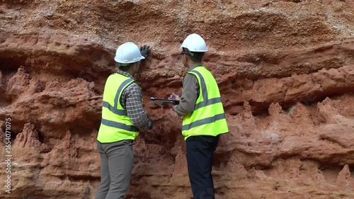 Geologist engineer working at mining site, excavating rock for analysis, checking soil minerals, identifying metals like gold, studying rock layers, and inspecting contamination for environmental safe