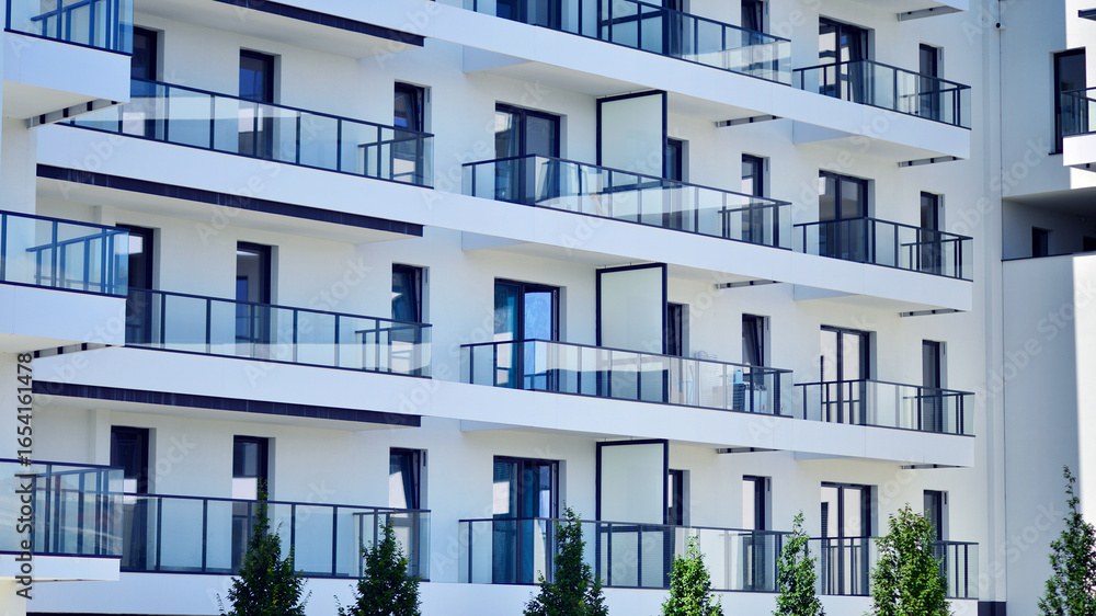Obraz premium Modern new residential apartment house building complex. Exterior view of modern apartment building. New construction apartment or condo complex.