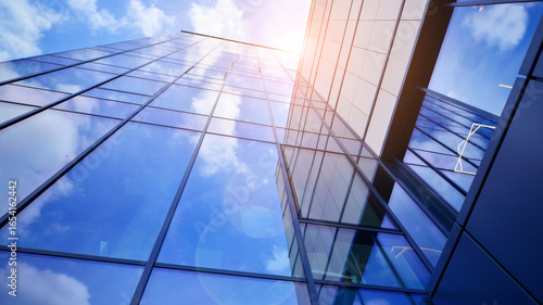 Wallpaper Mural Modern office building with glass facade. Transparent glass wall of office building. Reflection of the blue sky on the facade of the building. Torontodigital.ca
