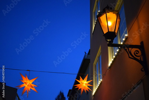 old town street light and Christmas stars in blue hours mood