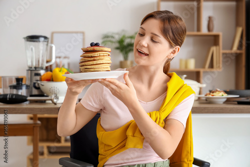 Young woman in wheelchair w...