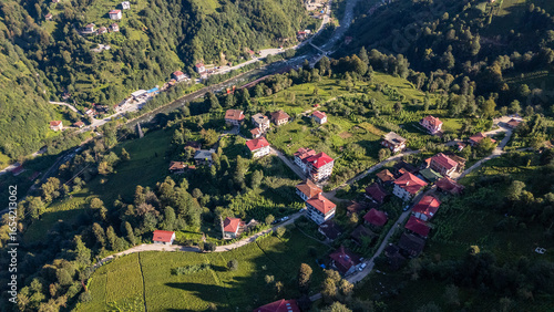 Fotografie Camlihemin village nestled on lush green hillside in Rize, Turkiye, offering bre