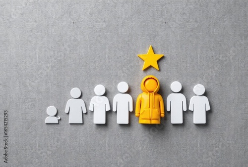 Figures with yellow figure and star on gray wall