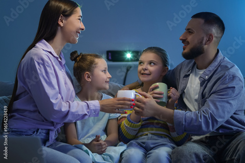 Happy family with cups of t...