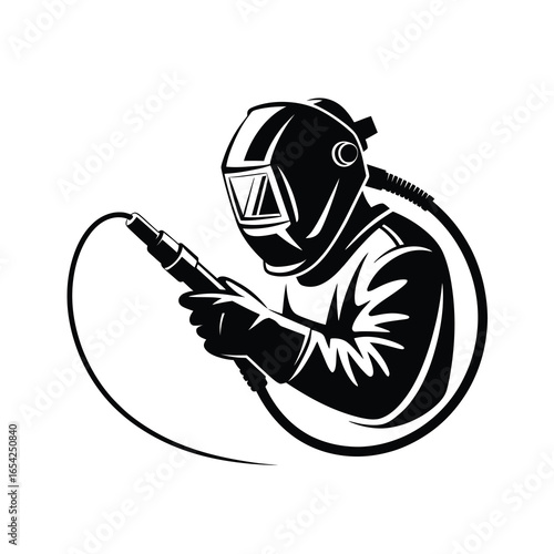 Welder in protective gear with welding torch and cable