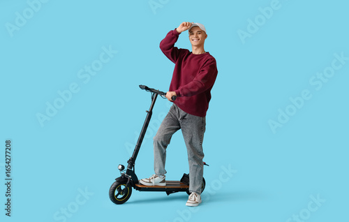Teenage boy in cap with ele...