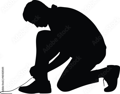 Man kneeling to tie shoelaces in a stark black silhouette