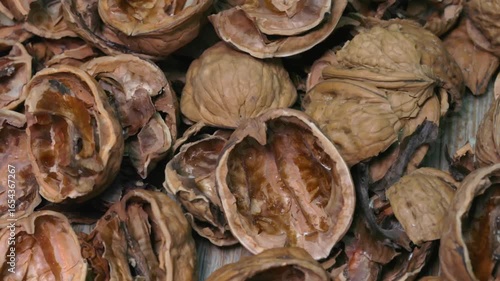Slow horizontal tracking shot of cracked walnut shells close-up in 4K