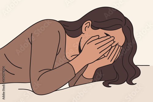 Sad tired and exhausted woman laying down covering her face with hands. Concept of depression, mental health issues, burnout, grief, loneliness and emotional stress.
