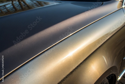 Close up of luxurious car paint finish showcasing reflective surface and smooth bodywork details
