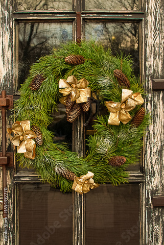 Christmas wreath on vintage door close-up.