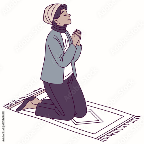 Person in hijab and modest clothing praying on a prayer mat with hands clasped