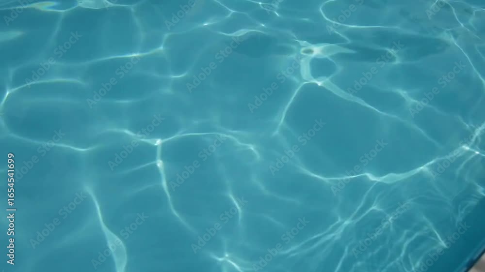 Blue ripped water in swimming pool Abstract water ripples on swimming pool blue color mosaic tiles refreshing blue Water surface texture Blue ripped water in swimming pool Abstract water ripples on swimming pool blue color mosaic tiles refreshing blue Water surface texture