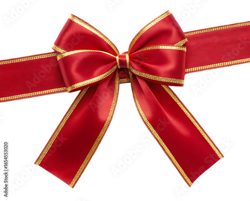 A shiny red bow with gold trim on a ribbon viewed from above against a black background in studio shot