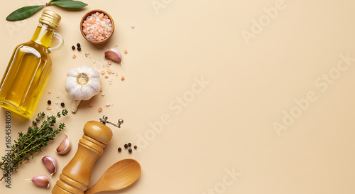 Minimalist flat lay of cooking essentials on pastel beige background. Olive oil bottle, pink Himalayan salt, black pepper grinder, thyme sprigs, garlic cloves, and wooden spoon placed on one side, lea