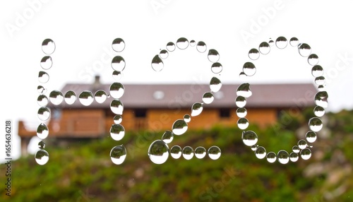 Water droplets spell H2O over a house