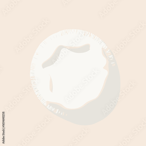 Round cotton makeup remover pad with subtle texture on beige background  