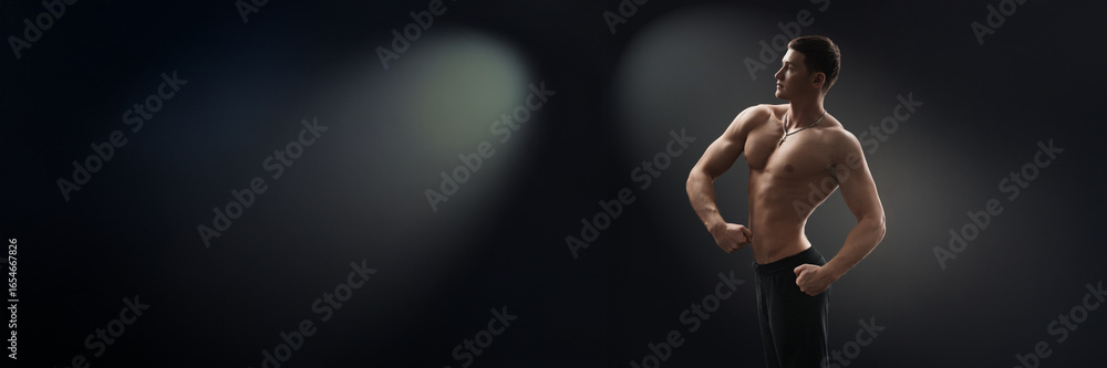 Naklejka premium Confident Pose of Muscular Man Wide Banner with Copy Space