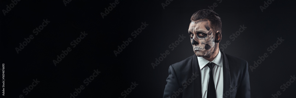 Fototapeta premium Skeleton Face Painted Man in Suit Wide Banner with Copy Space