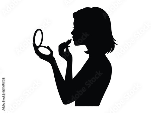 Silhouette of a woman applying lipstick with a compact mirror