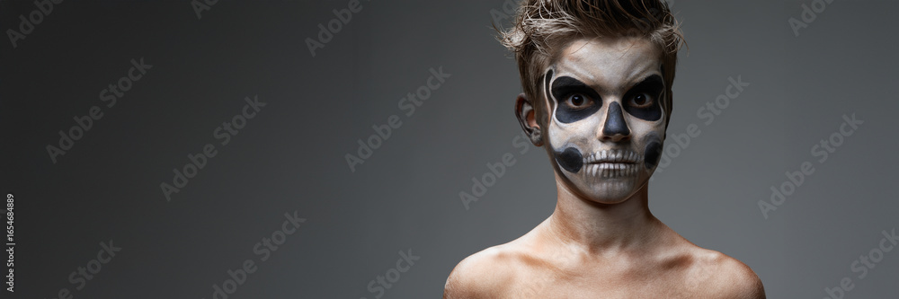 Obraz premium Boy with Skeleton Face Paint Wide Banner with Copy Space