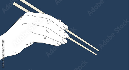 Elegant hand holding chopsticks ready to enjoy delicious asian cuisine