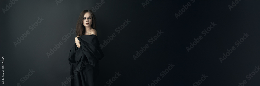 Fototapeta premium Woman in Black Attire with Dramatic Look Wide Banner