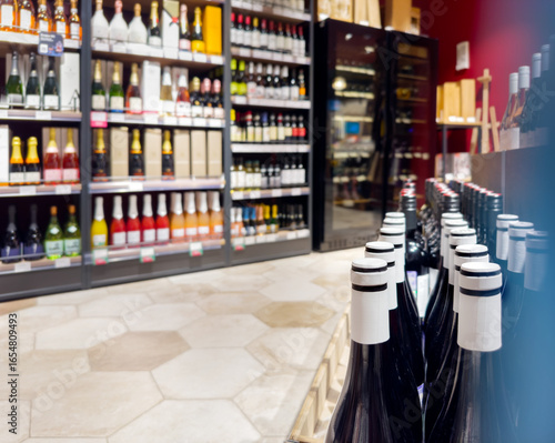 defocused alcohol (wine, champagne, liquor, whiskey) on store shelves