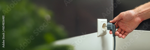 Obraz na plátně Hand Plugging Cord in Socket Wide Banner
