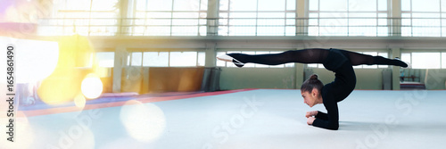 Schilderij op canvas Gymnast performing a split in wide banner with copy space
