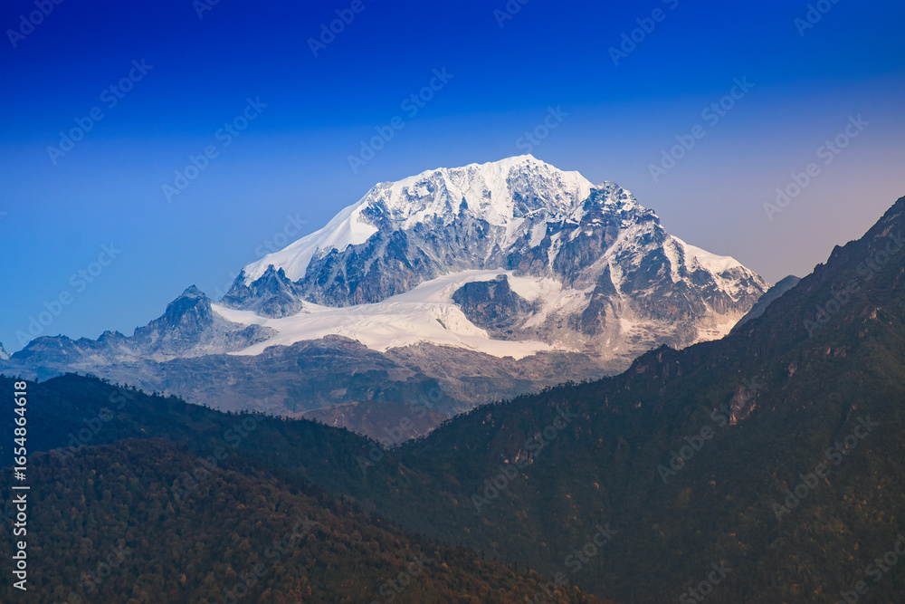 Fototapeta premium Beautiful first light from sunrise on Mount Pandim, at an elevation of 6,691 m , 21,952 ft above sea level. Himalayan mountain range, Sikkim, India. Sikkim is popular for tourists from all over India.