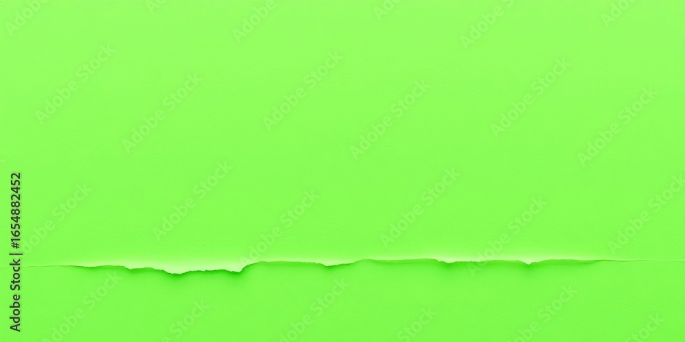 Fototapeta premium Jagged-edged piece of green paper, torn from a larger sheet, showing textured fibers, edge, background texture