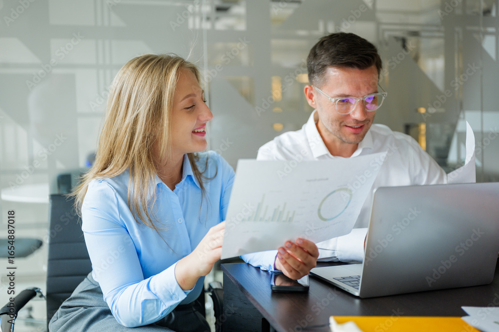 Business professionals collaborate over data analysis at a modern office workspace Business professionals collaborate over data analysis at a modern office workspace
