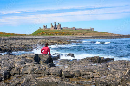 woman looking at ruin of Du...