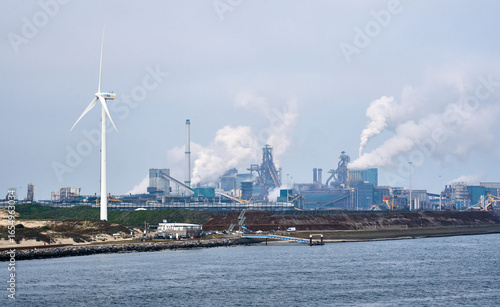 Photography Harbour entrance with breakwave and lighthouse and oil refineries in background