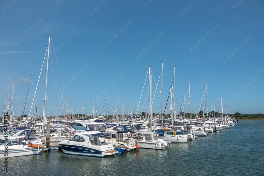 Lymington England - August 17 2025: boats in the marina at Lymington Hampshire with blue sky and clear reflections in the water Lymington England - August 17 2025: boats in the marina at Lymington Hampshire with blue sky and clear reflections in the water
