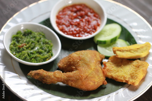 Indonesian fried chicken with sambal red chili, tofu,cucumber and tempe