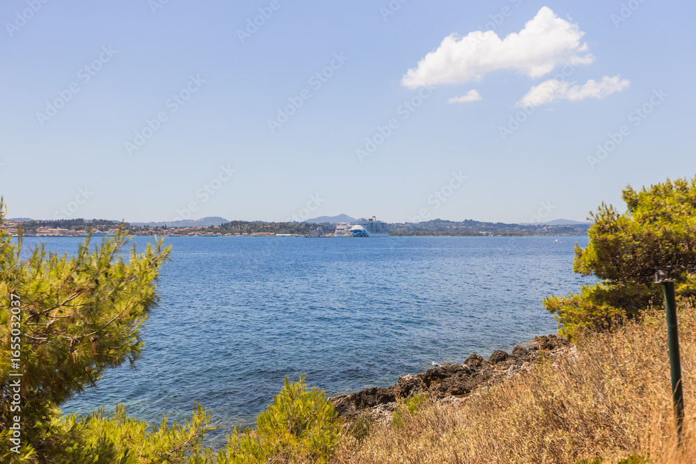 Fototapeta premium Historic Vido island coastline, known as Blue Tomb where Serbian soldiers were buried at sea during World War I, featuring pristine turquoise waters and memorial significance in Greek waters.