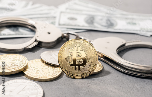 Crypto crime fraud concept. Bitcoin and crypto coins, handcuffs and US dollar banknotes
