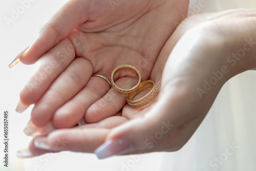 Canvastavla Decorative wedding rings are held gently in a woman's palms, symbolizing love and unity