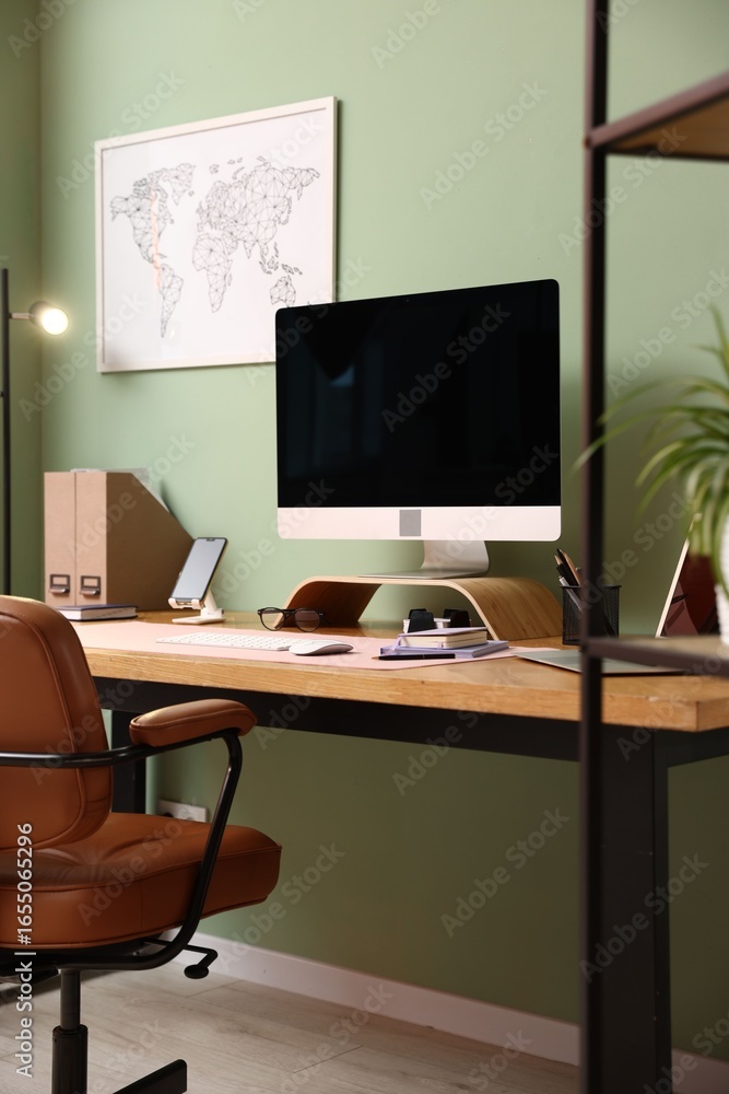 Fototapeta premium Stylish workplace with modern computer and stationery on wooden desk indoors