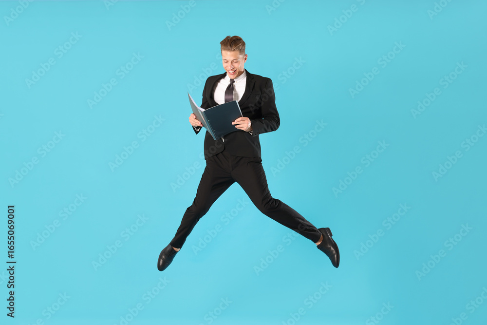 Fototapeta premium Businessman with folder jumping on light blue background