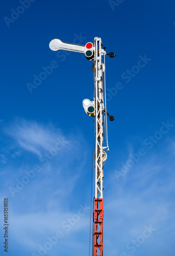 Old railway semaphore against blue sky. Close-up.