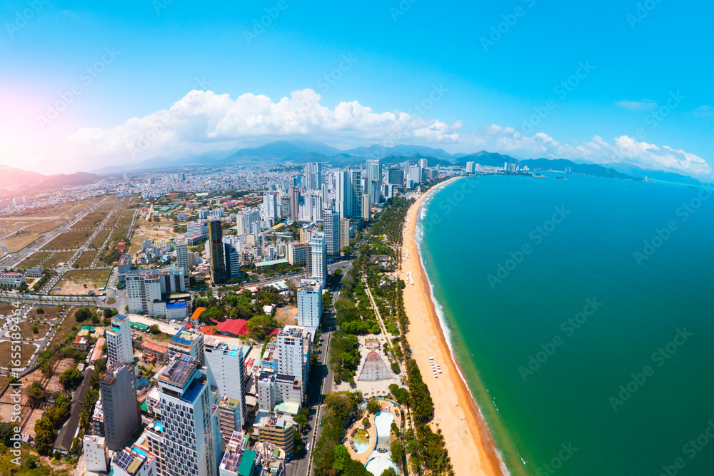 Obraz premium Central beach overlooking panoramic aerial view city shadow on the coast of Southeast Asia in afternoon Nha Trang.
