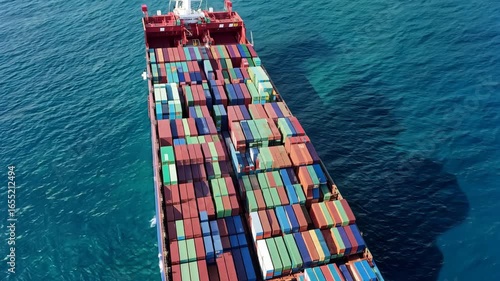 aerial glide over a brightly colored container ship