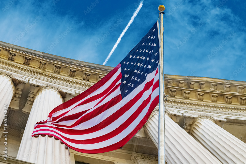 Fototapeta premium United States flag flies proudly on Washington government building, representing American patriotism, authority, and classical national heritage.