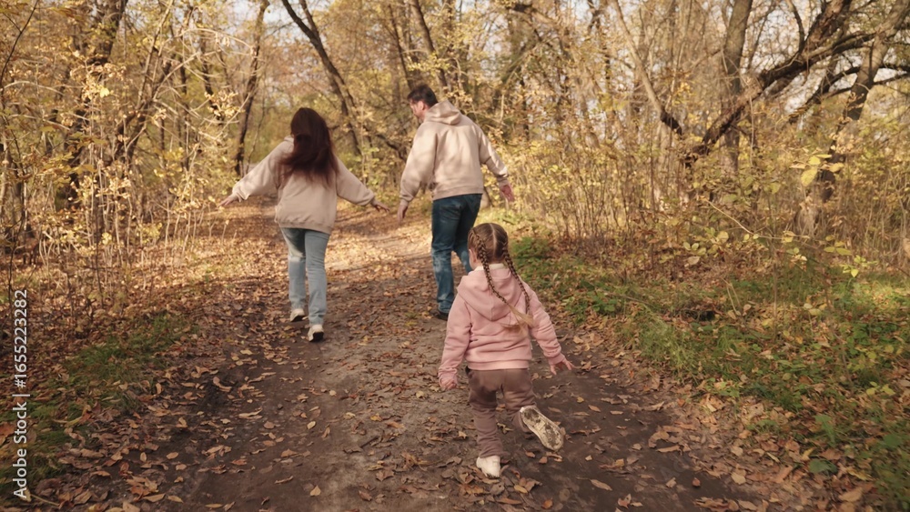 Fototapeta premium little kid runs catching up with mother and father, happy family, active children outdoor games autumn, cheerful joyful child with mom and dad laughing, vacation travel together, children dream fun.